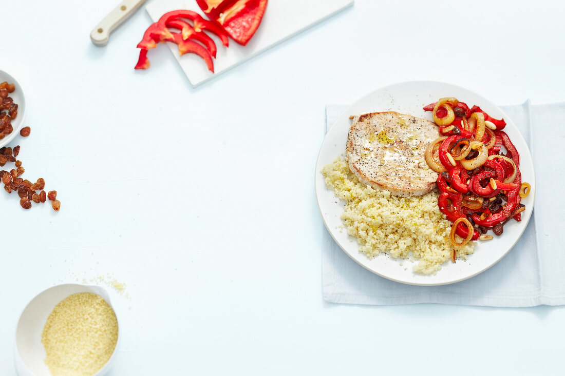Swordfish with peppers on plate