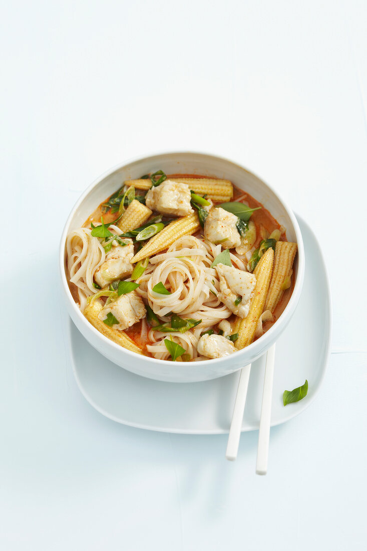 Fish curry with noodles and baby corns in bowl