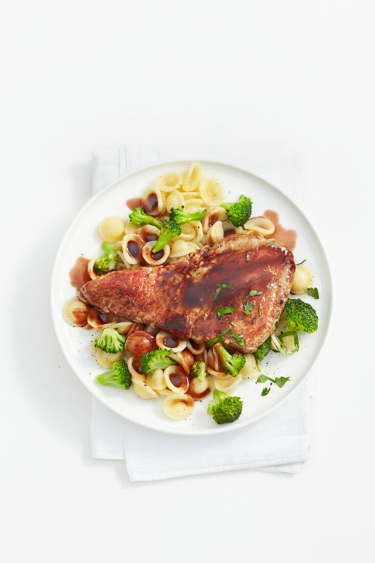 Marsala schnitzel with orecchiette on plate