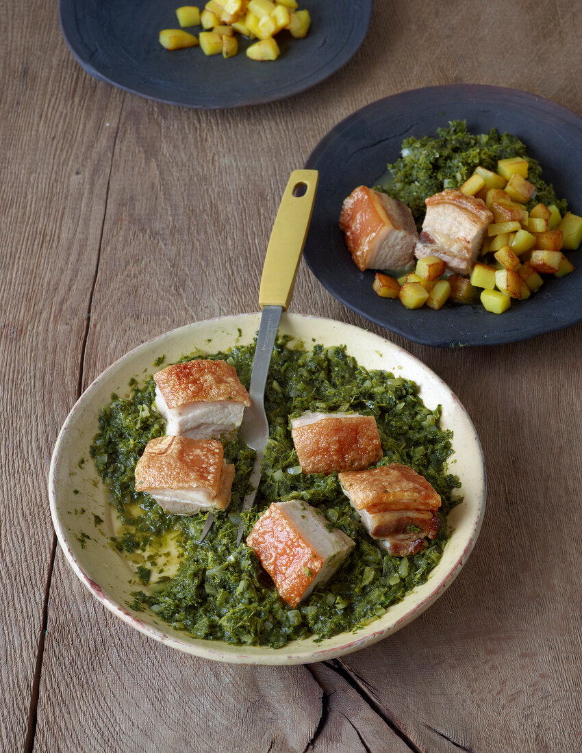 Kale with crispy pork belly in bowl