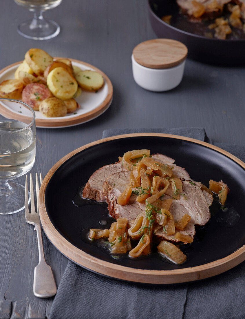 Roast pork with potatoes and fennel in serving dish