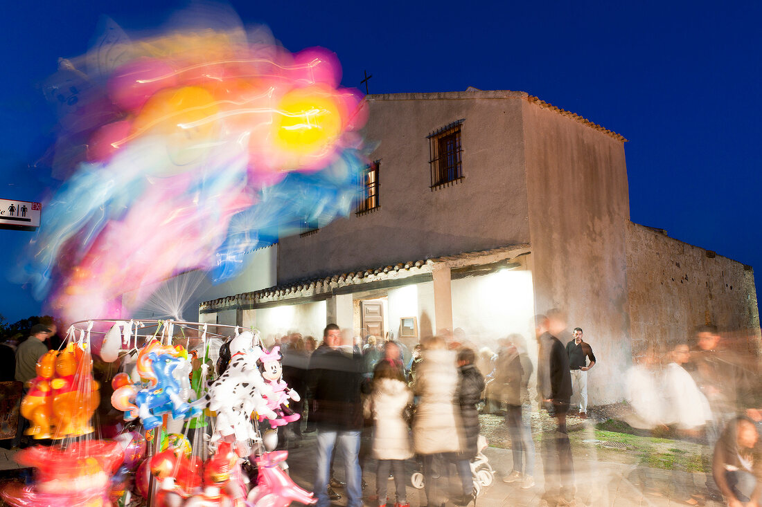 People at Sant'Efisio Church at blue hour, Nora, Cagliari, Sardinia, Italy, blurred motion