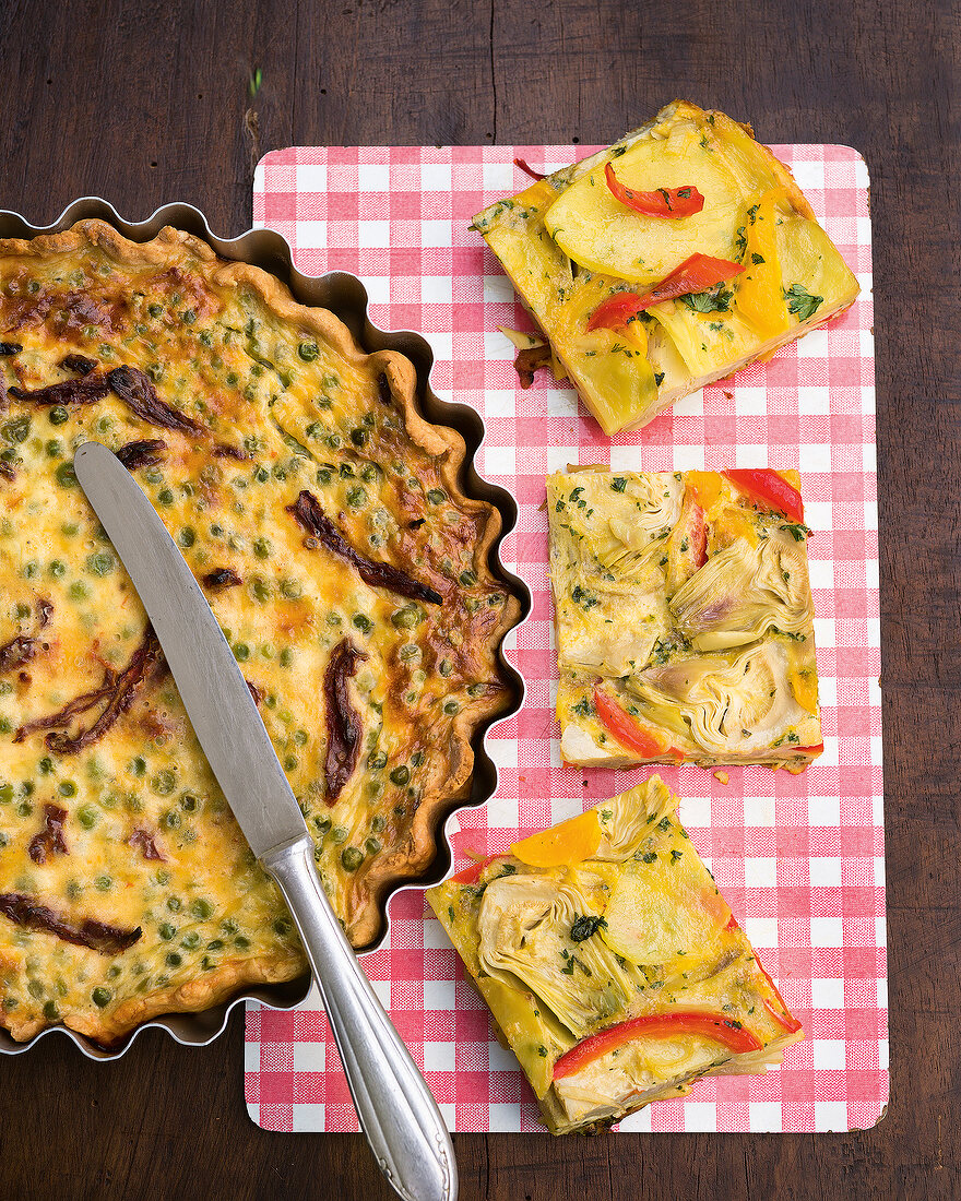 Vegetable tortilla with peas and tomato quiche on tray