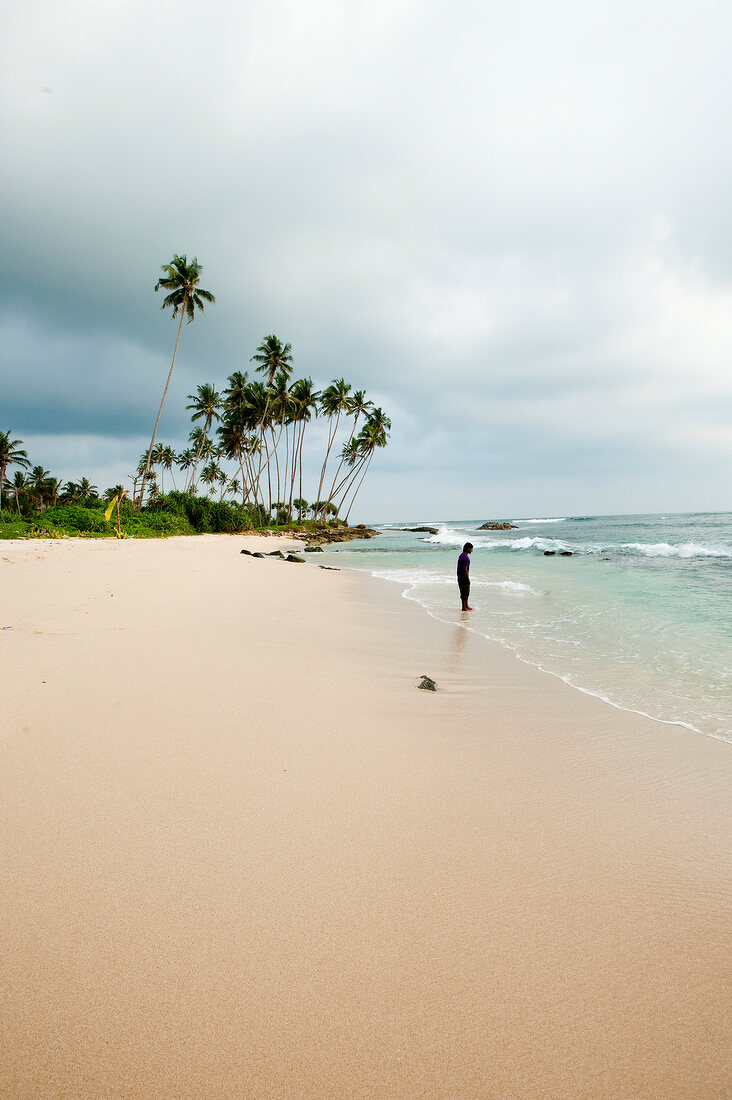 View of man on beach at Weligama, Sri Lanka