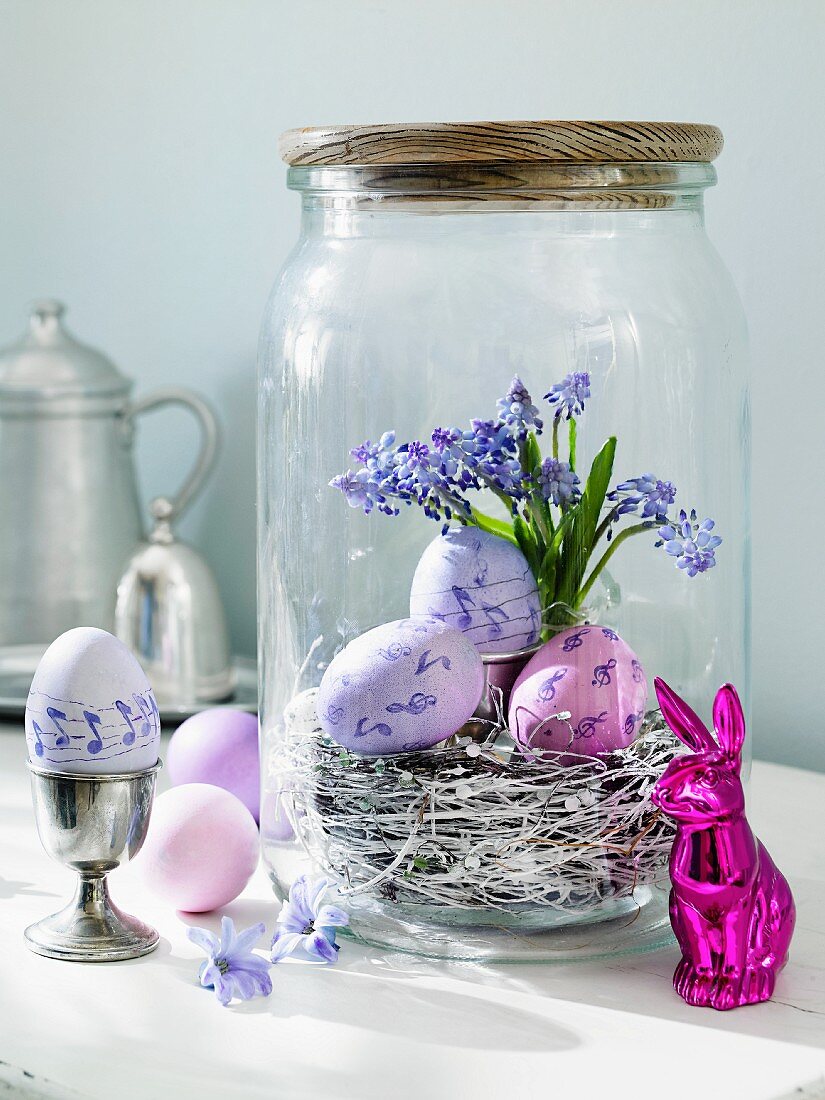 Purple Easter eggs in a preserving jar with an Easter bunny in front of it