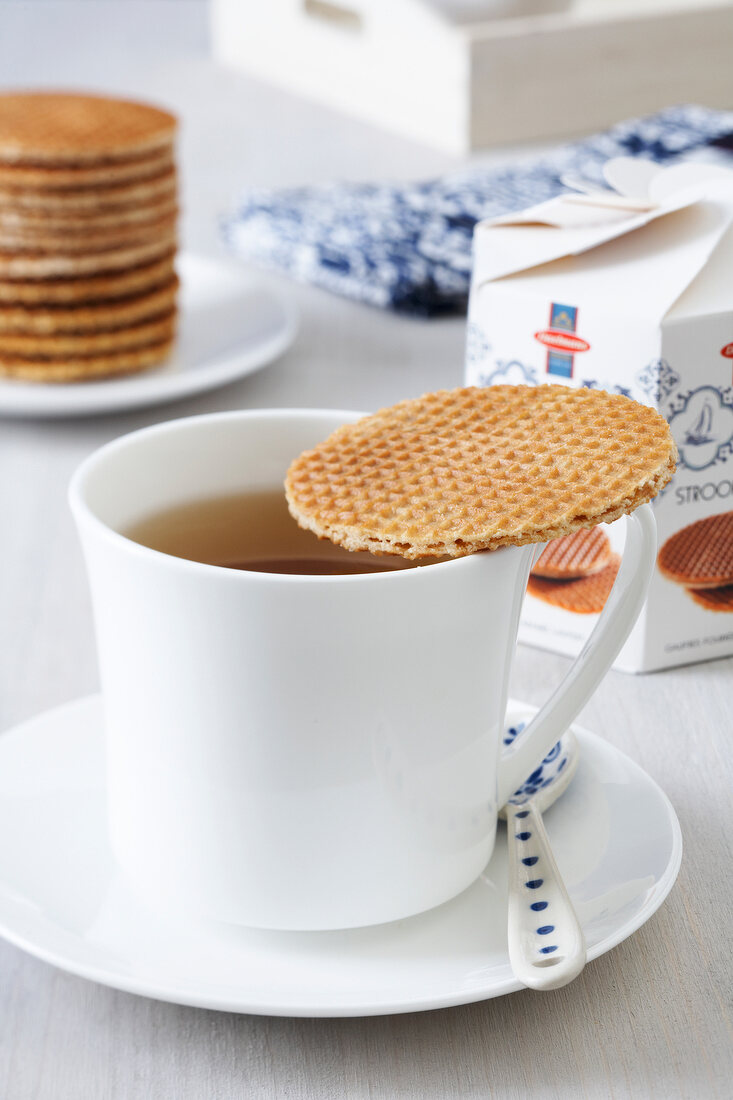 Teacup with Dutch waffle on it
