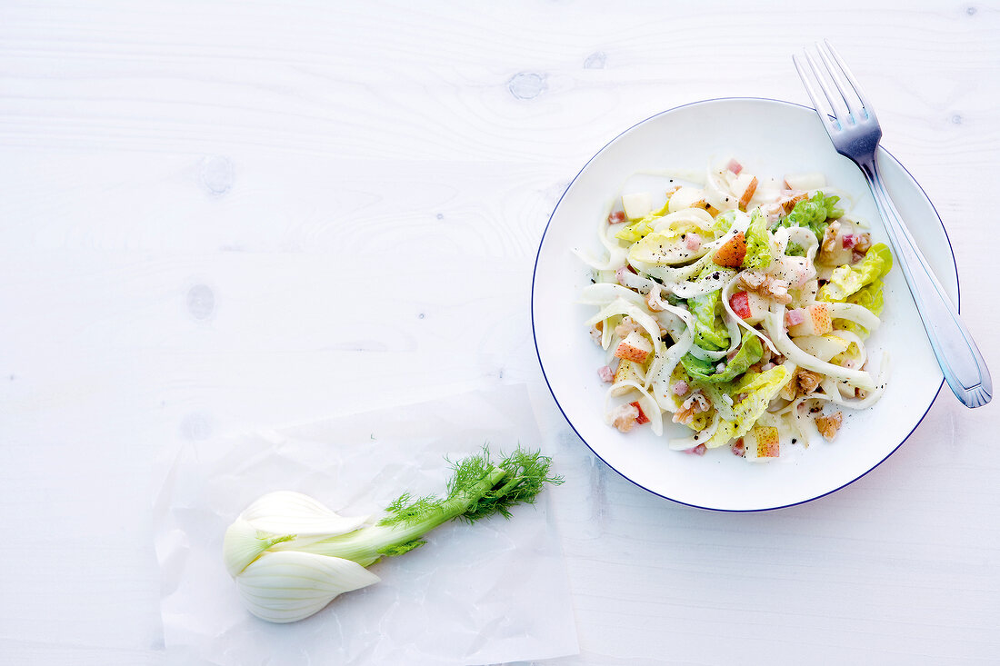 Fruity ham salad with fennel bulb on plate