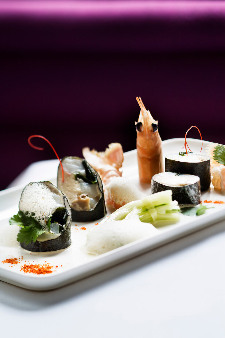 Pieces of sushi and prawn in serving plate