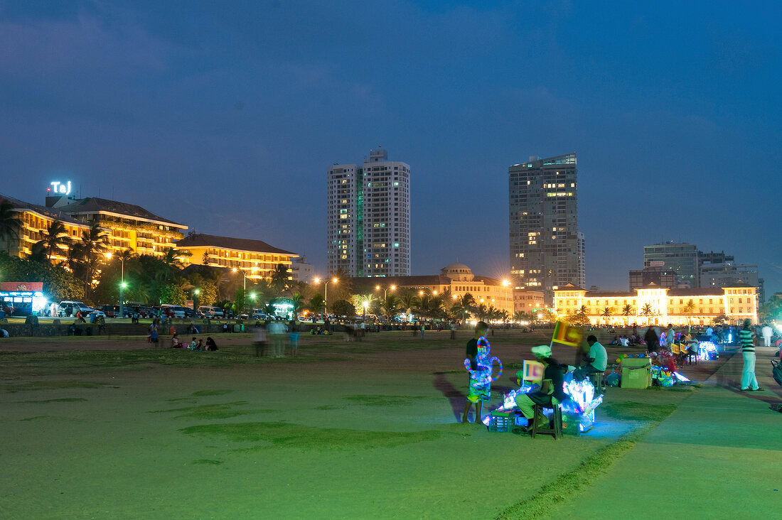View of people at Galle Face Green skyscrapers at night, Colombo, Sri Lanka