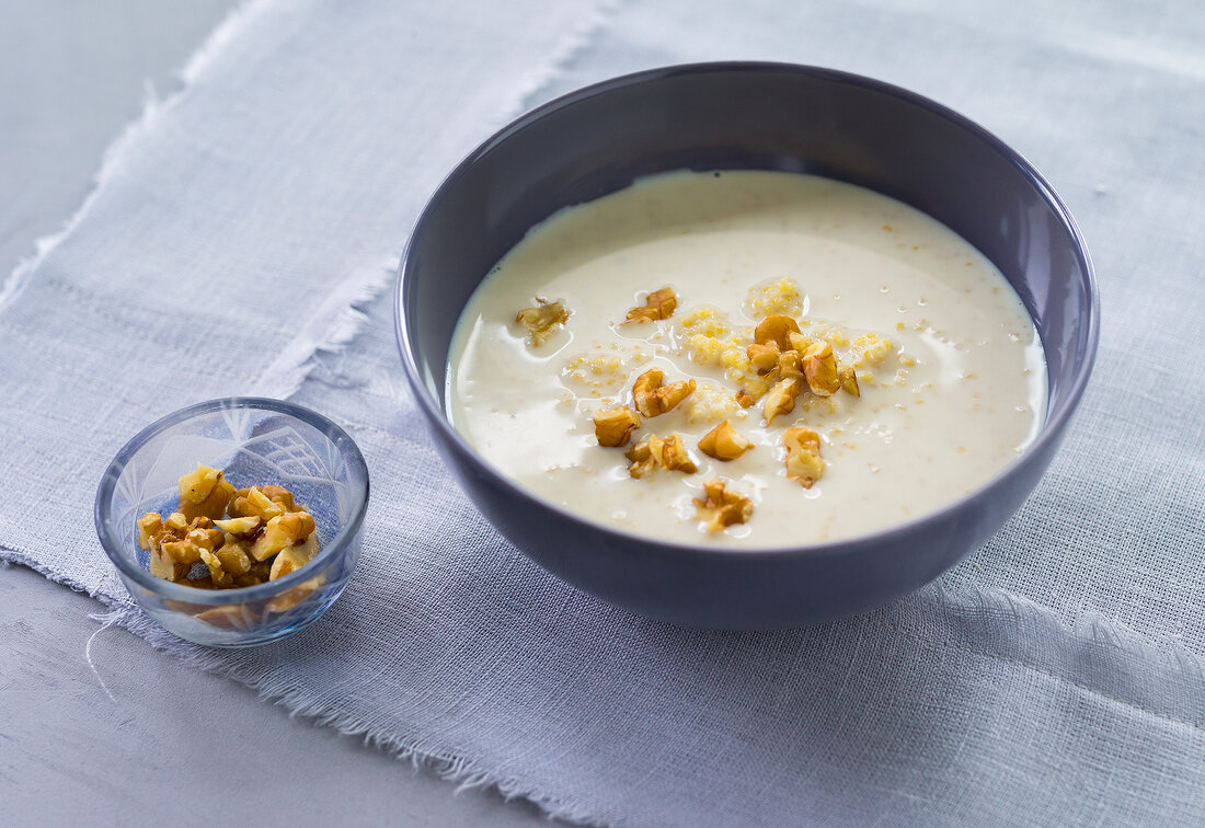Millet porridge with chopped walnuts in bowl