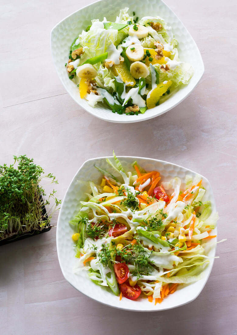 Chinese cabbage salad with walnuts and mixed salad in bowls