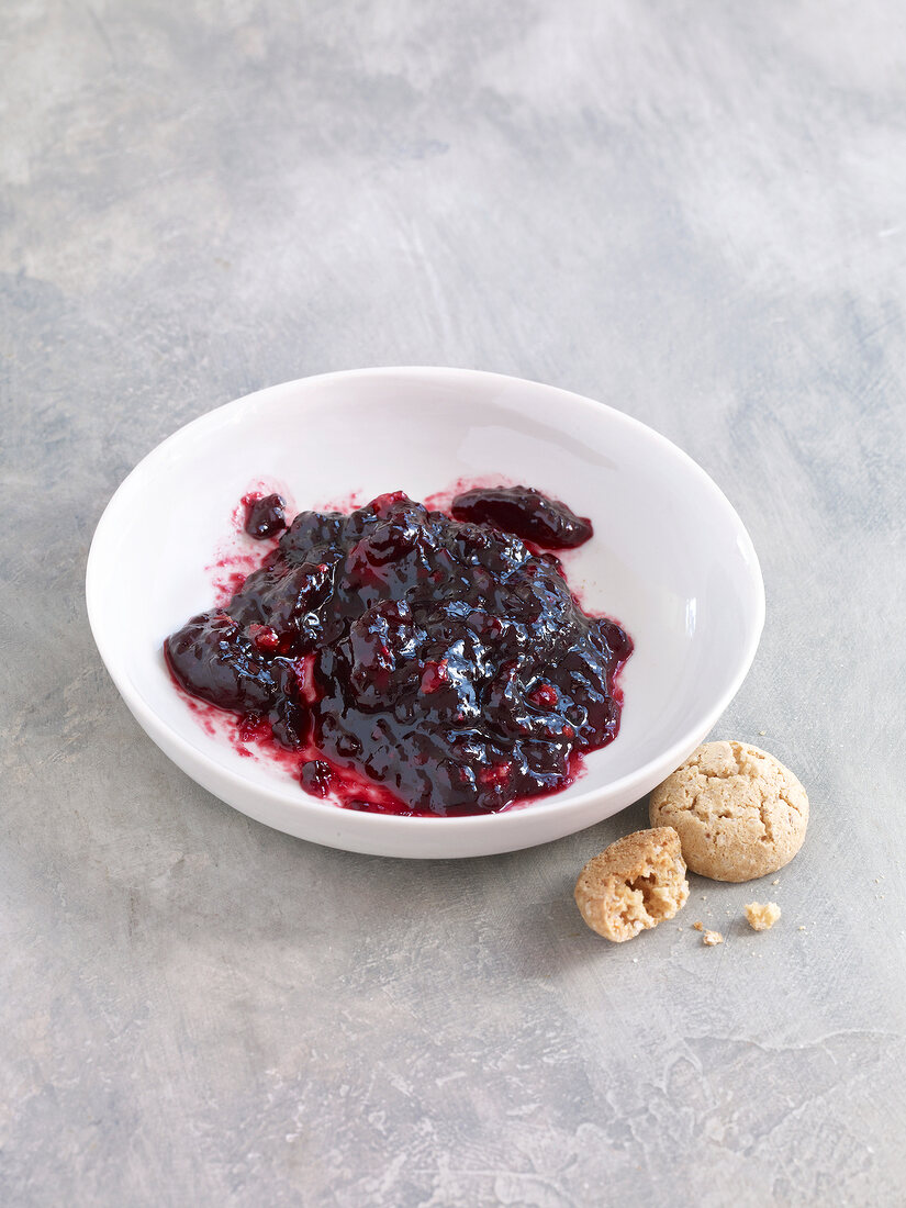 Blackberry jam with amaretti in bowl