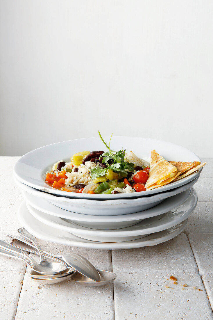 Dish with rice and vegetable with quesadillas on stacked dishes