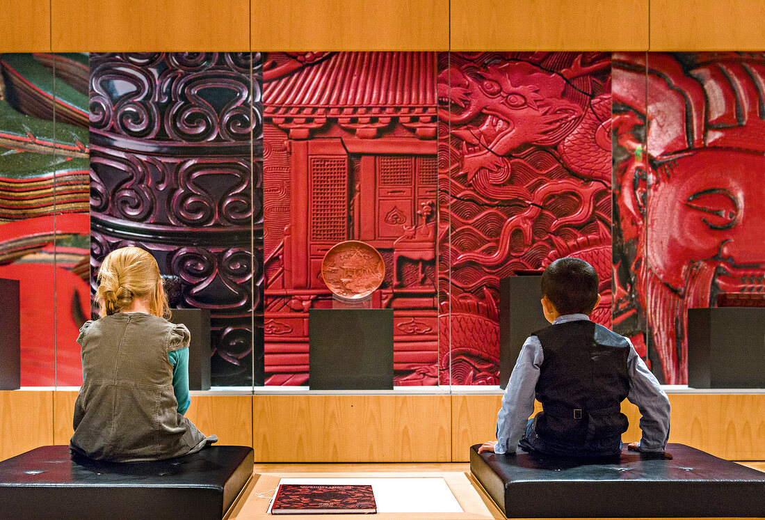 Two children watching Asian Art in The National Museum, Berlin, Germany