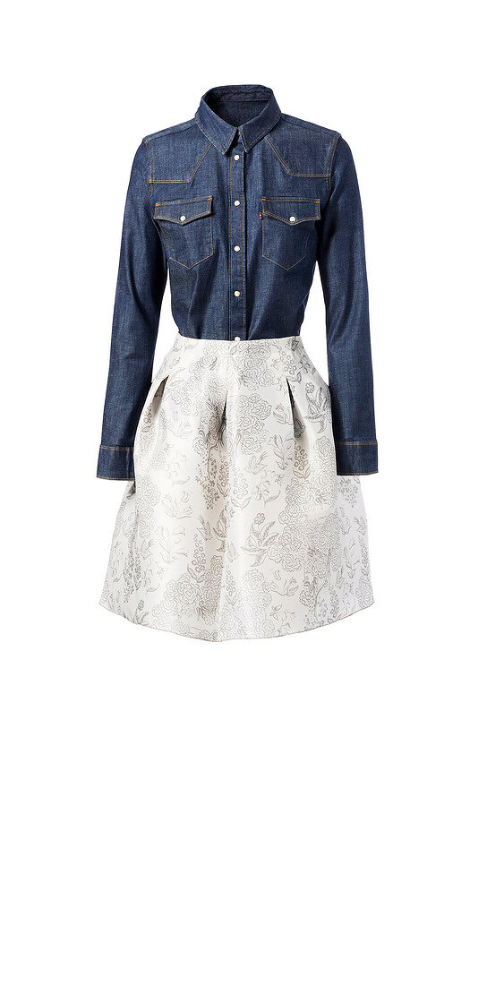 Denim shirt and floral patterned silk skirt for office wear against white background