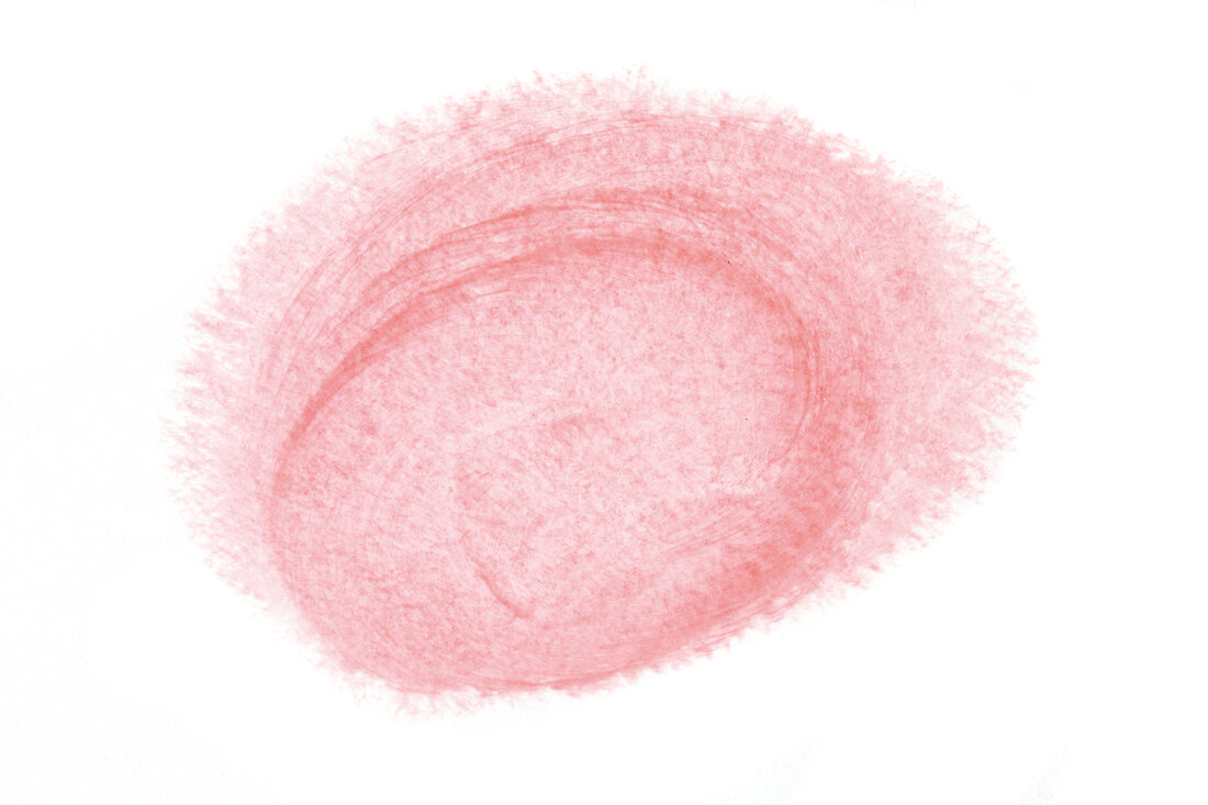 Close-up of lipstick smudged on white background 