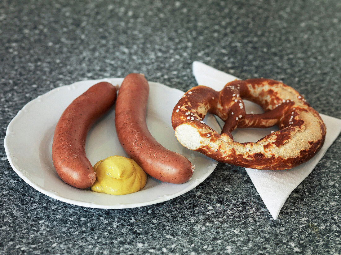 Horsemeat sausages on plate with pretzel