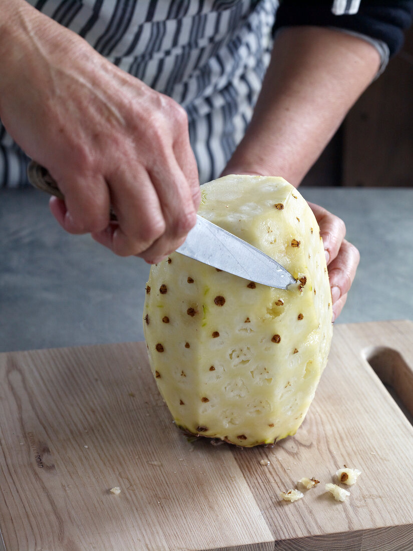 Close-up of cutting out pineapple eye for preparation of jam