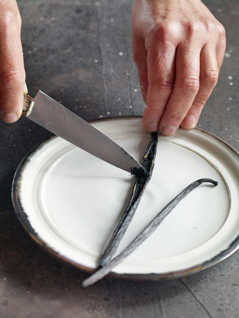 Close-up of scraping out vanilla bean for preparation of jam
