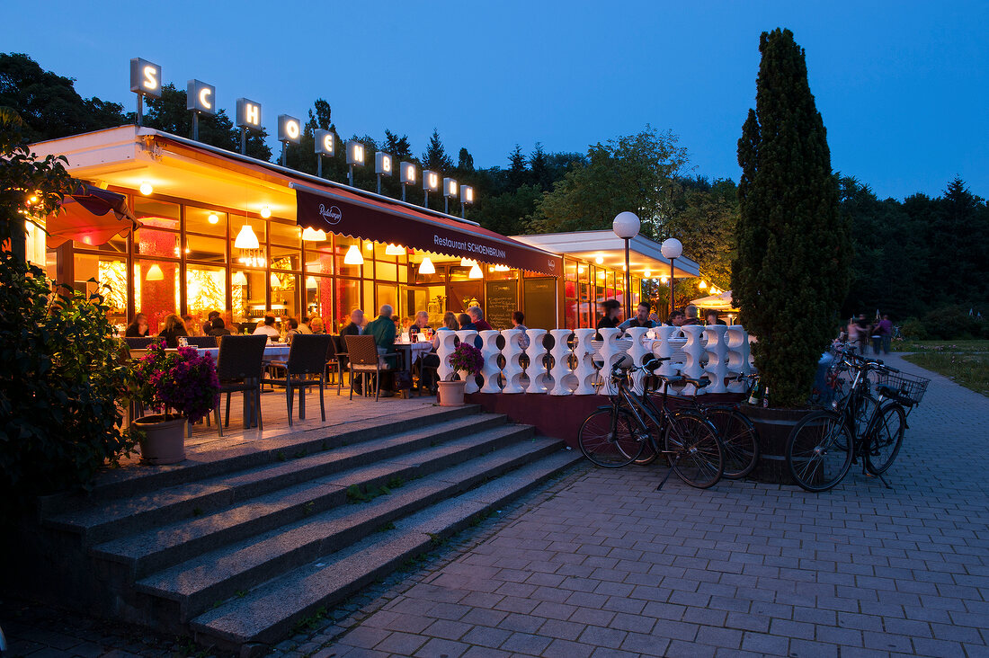 People at restaurant Schonbrunn at night in Volkspark Friedrichshain, Berlin, Germany