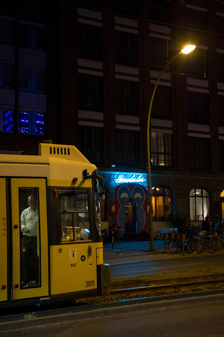 Tram in front of Michelberger hotel at night, Friedrichshain, Berlin, Germany
