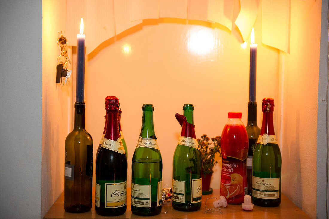 Lighted candles and various bottles of champagne, Neukolln, Berlin