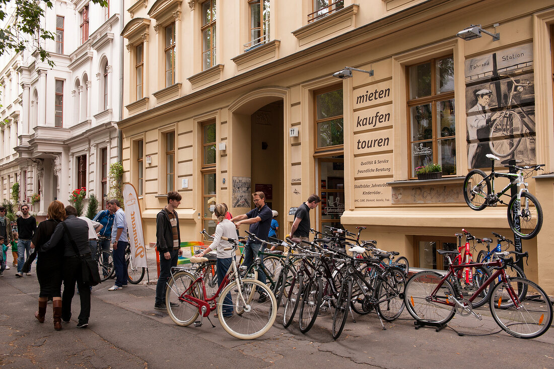 People standing in front of bicycles for rent in Prenzlauer Berg, Berlin, Germany