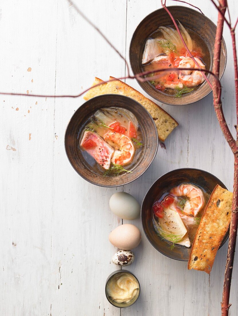 Fish and prawn stew with fennel, orange aioli, bread and eggs