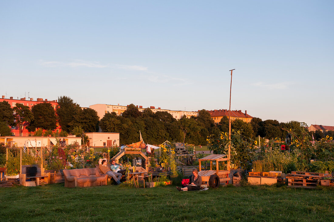 People in Tempelhof field garden at sunset, Berlin, Germany