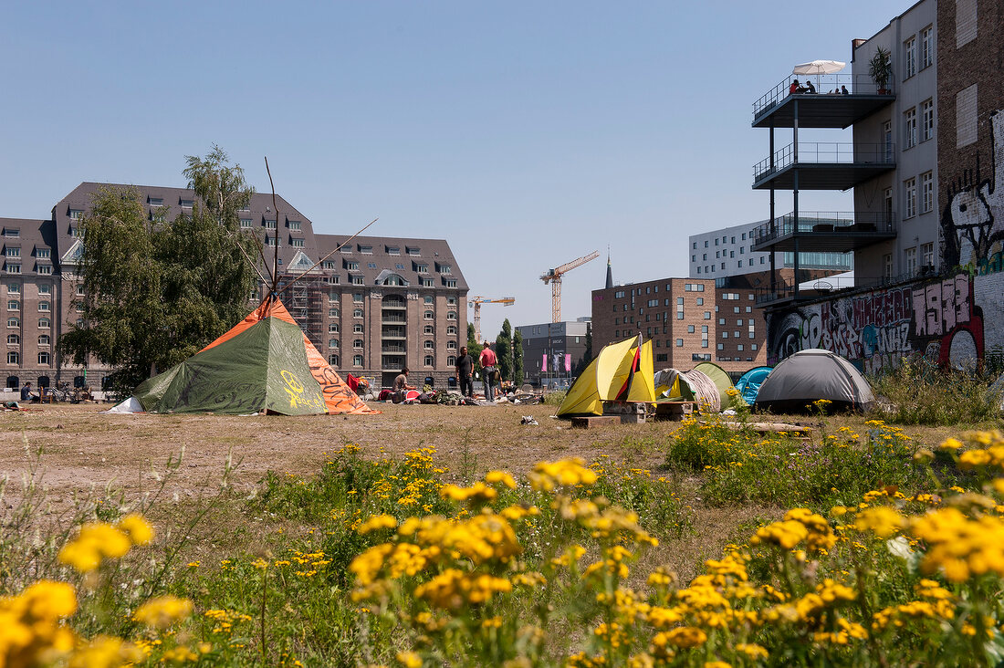 View of open space with tents and building in Schlesisches Tor, Berlin, Germany