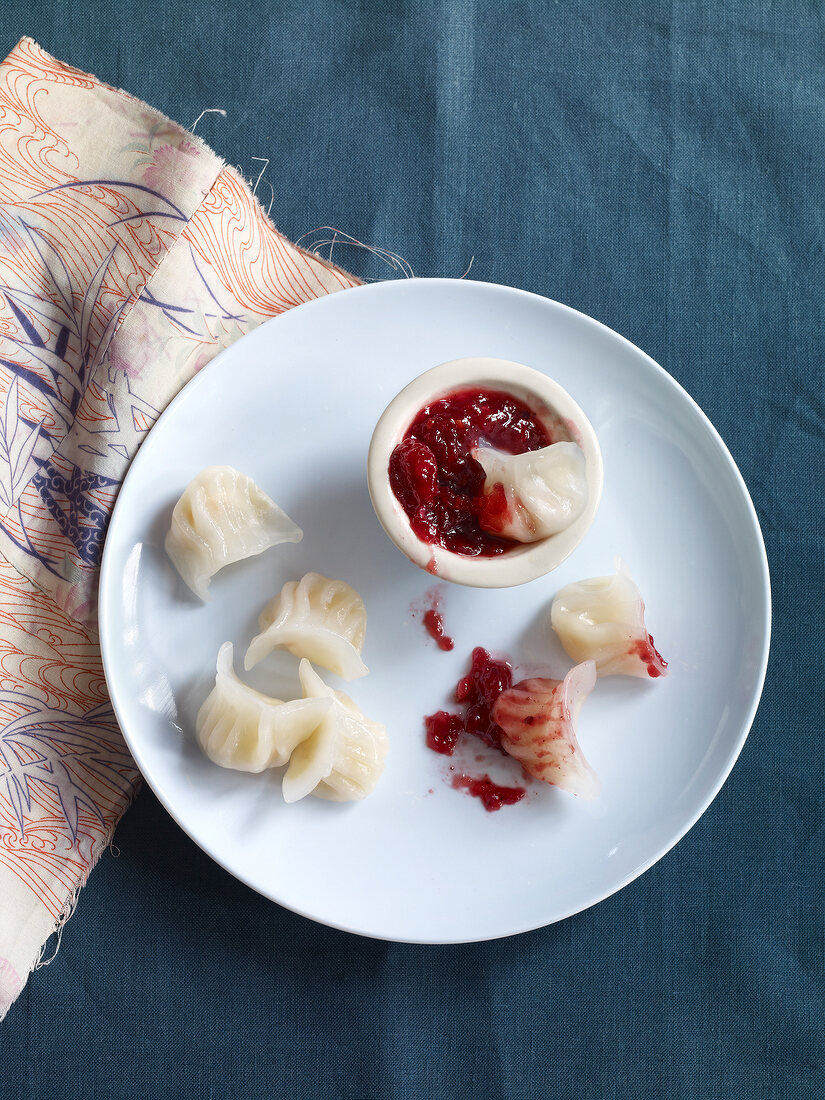 Sweet dumplings and sour and spicy current sauce on plate