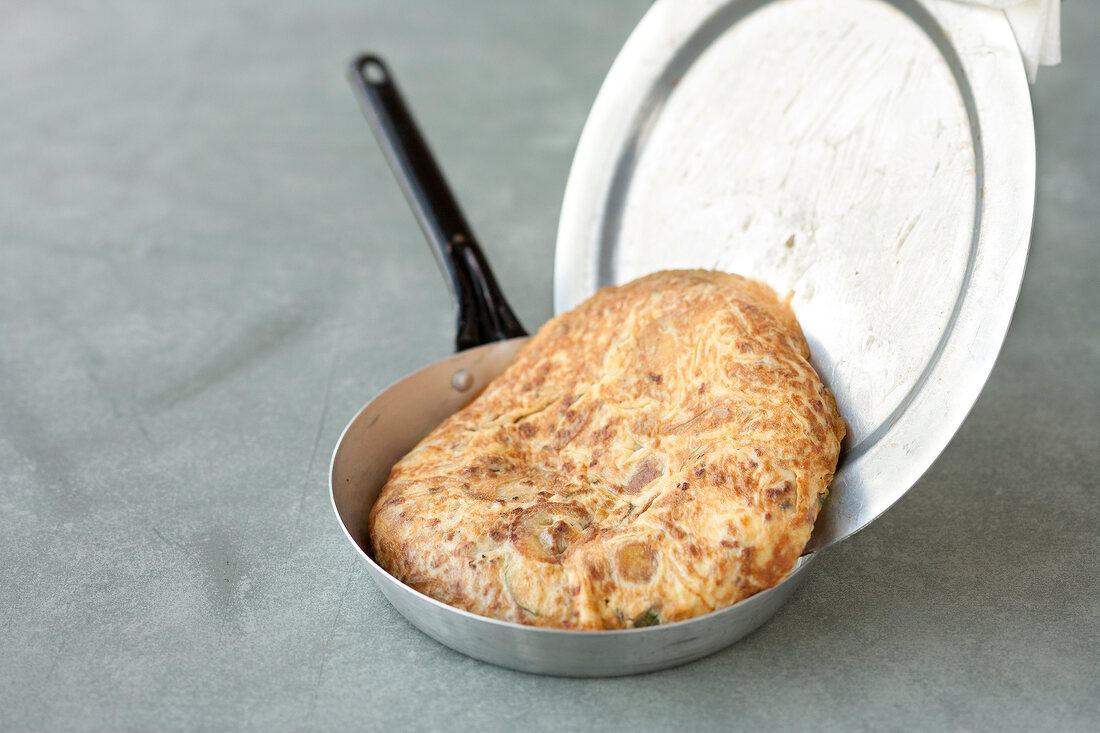 Tortilla being put in pan, step 2