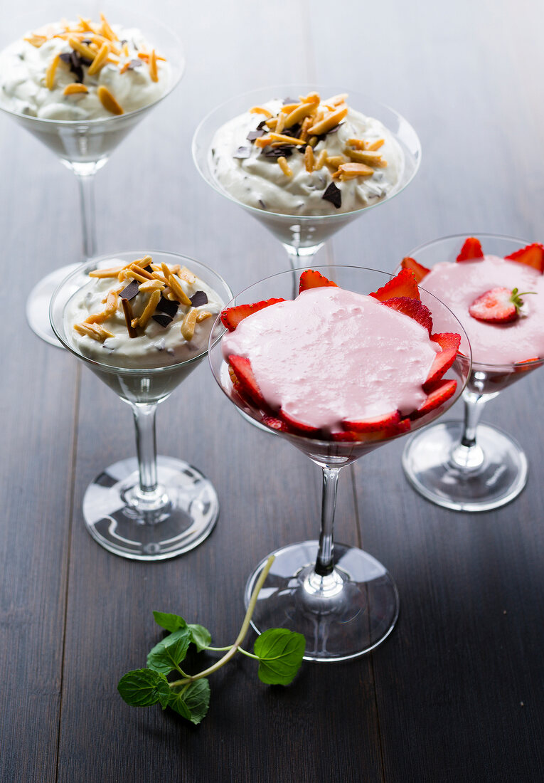 Strawberry quark with marzipan and stracciatella cream in martini glass