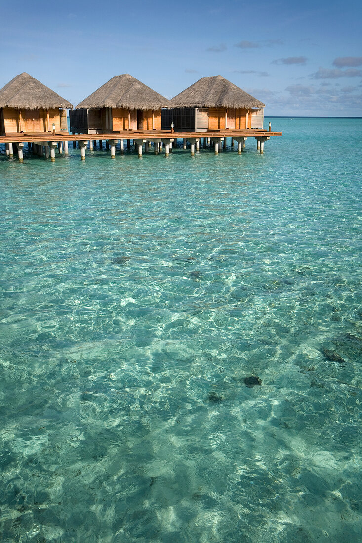 Dhigufinolhu bungalows in water at dock in Maldives island