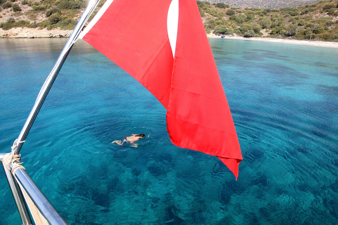 Person swimming near Datca Peninsula in Aegean, Turkey
