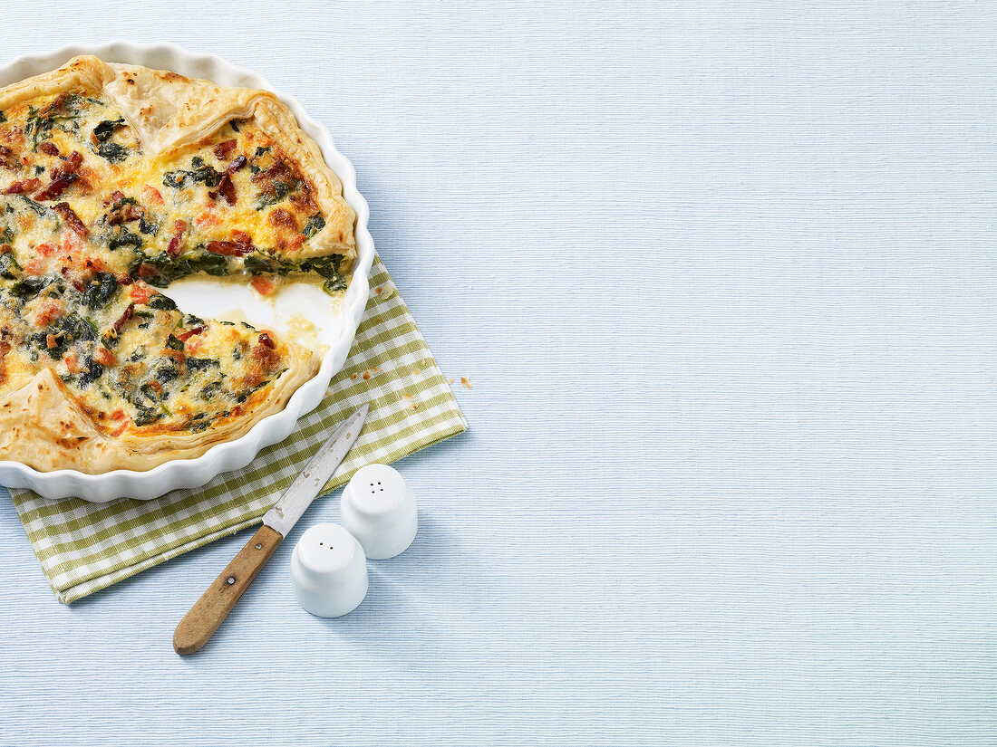 Spinach puff pastry quiche in baking dish