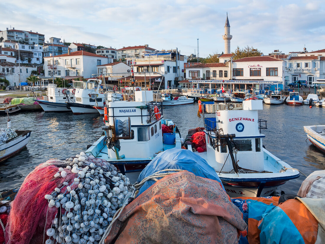 View of boat at harbor and cityscape with mosque in Bozcaada, Turkey