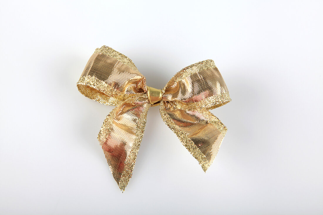 Gold, shiny bow on white background