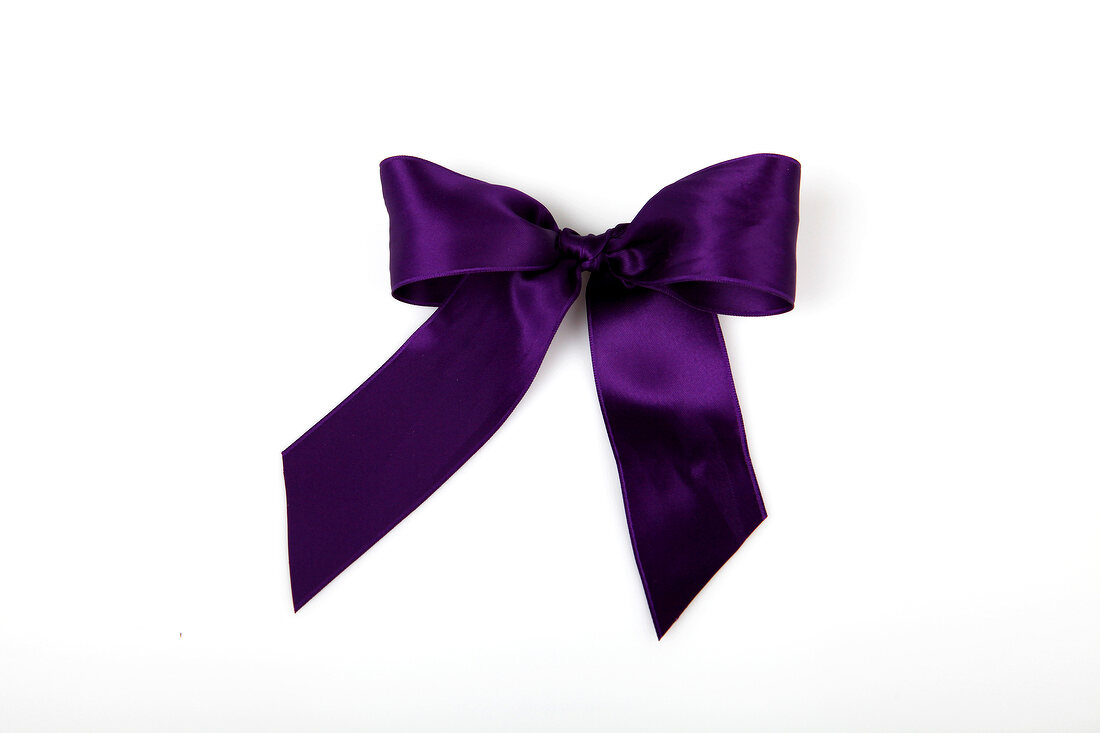 Purple shiny stain bow on white background