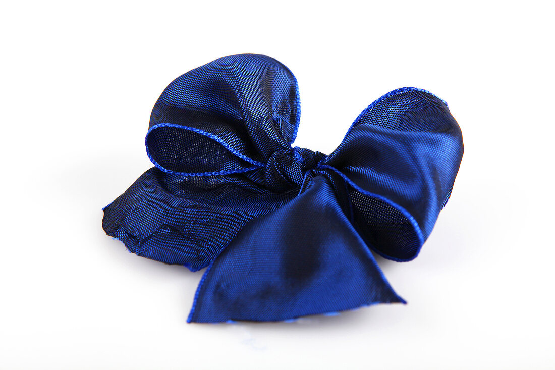 Blue shiny ribbon bow on white background