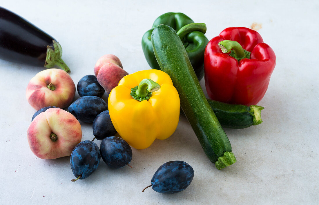 Various vegetable and fruits like zucchini, eggplant, bell peppers and peaches