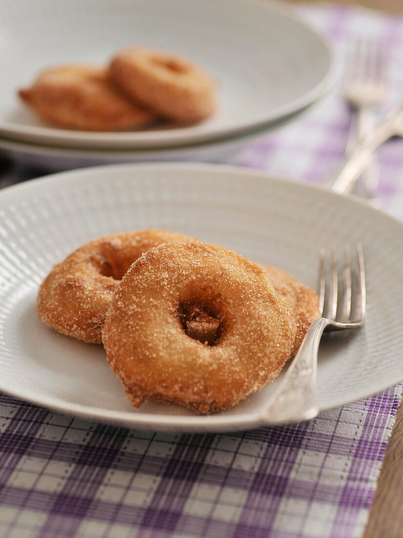 Apple fritters with cinnamon sugar on plate