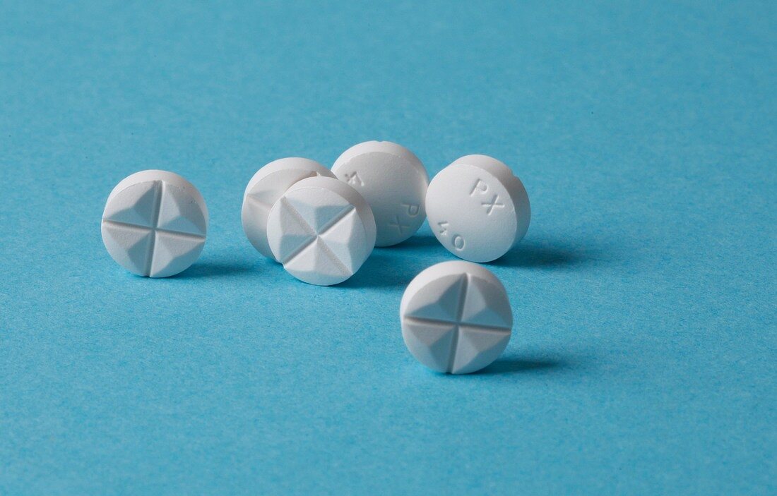 Close-up of white tablets on blue background
