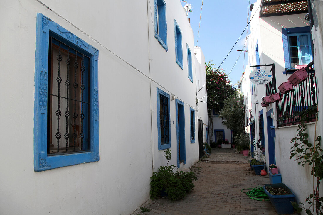 View of alley between blue and white buildings in Bodrum Peninsula, Aegean, Turkey