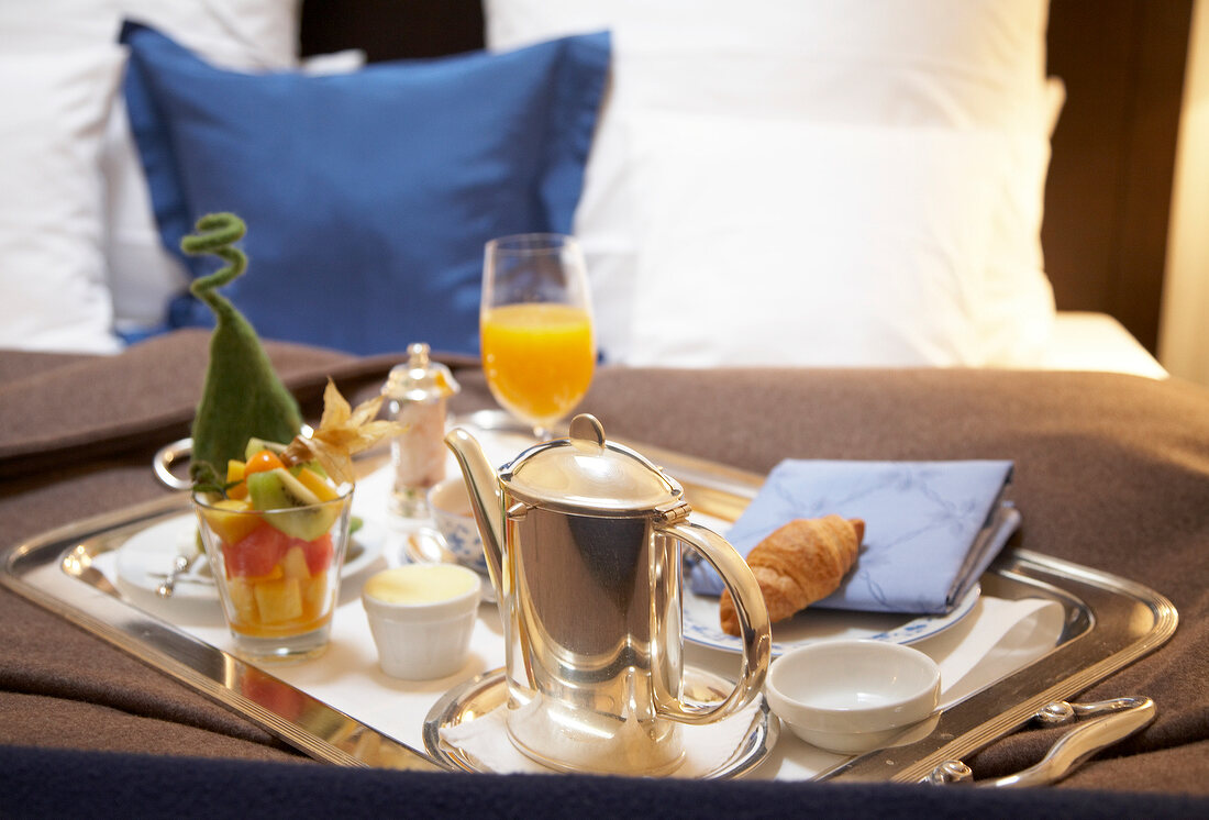 Breakfast tray on bed in hotel room