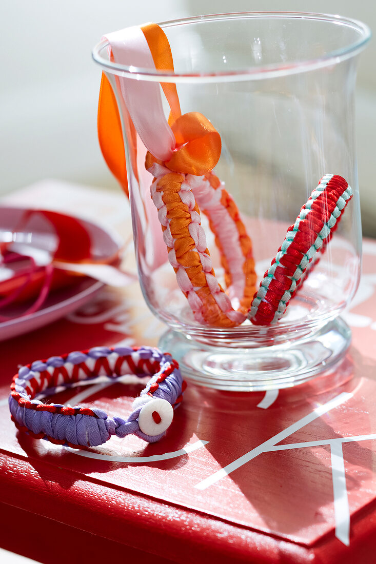 Macrame bracelets in glass jar and lying around