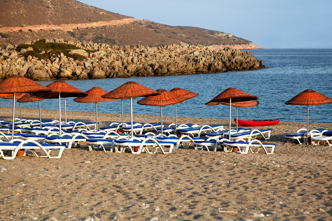 Sun loungers and sun umbrellas on Palamutbuku beach, Aegean Region, Turkey