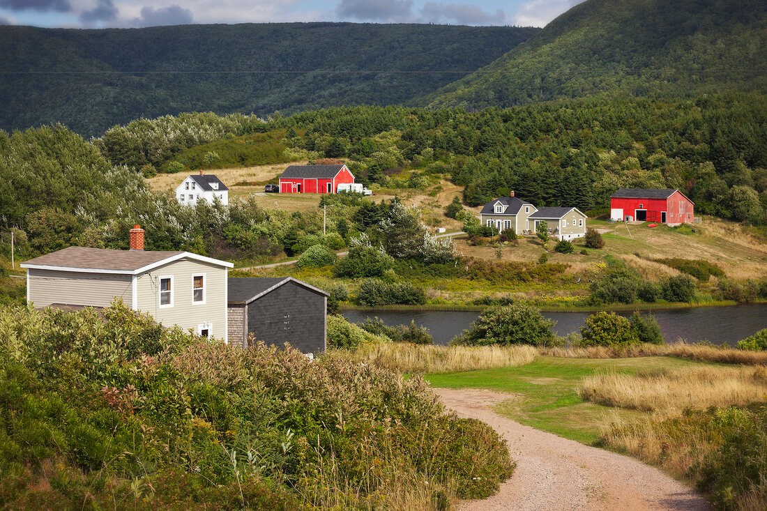 Landscape with wooden houses and mountain, Cape Breton Island, Canada