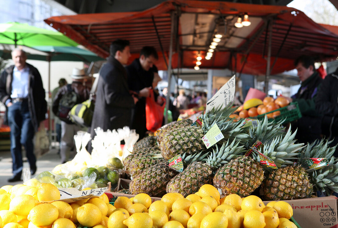 Market stall with fresh tropical fruits, pineapple, lime