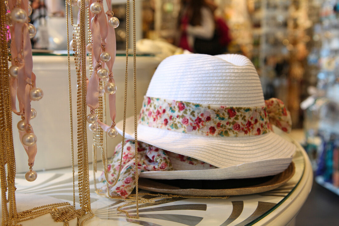 Stack of hats with woman accessories in store